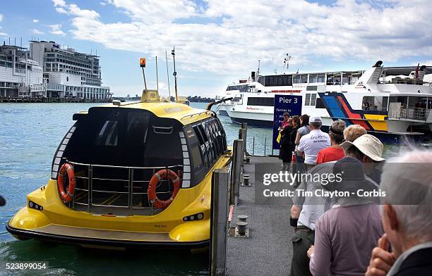 Passengers board a water taxi at The Ferry Terminal at Auckland Harbour, showing the Hilton Hotel in the background. Auckland, New Zealand, 31st...