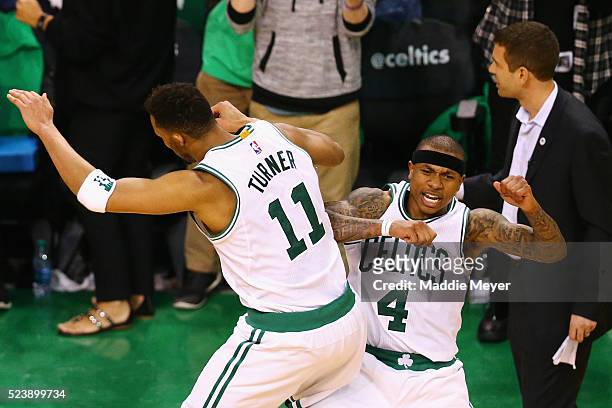 Isaiah Thomas of the Boston Celtics celebrates with Evan Turner after hitting a three pointer during overtime of Game Four of the Eastern Conference...