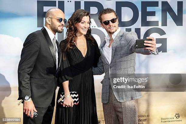 Actor Abdullah Al Muslemani, austrian actress Amira El Sayed and actor and producer Arcadiy Golubovich make aselfie during the German premiere for...