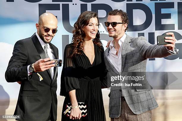 Actor Abdullah Al Muslemani, austrian actress Amira El Sayed and actor and producer Arcadiy Golubovich make aselfie during the German premiere for...