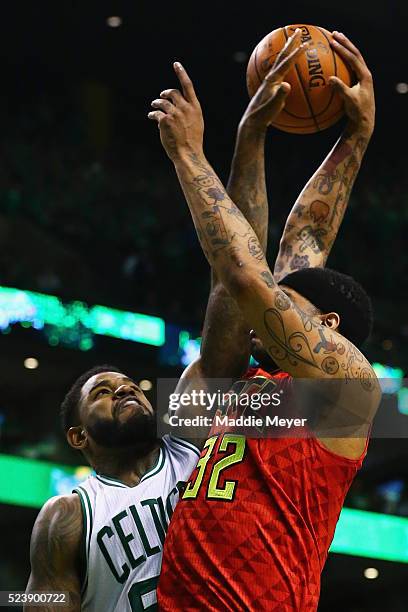 Amir Johnson of the Boston Celtics blocks a shot by Mike Scott of the Atlanta Hawks during the third quarter of Game Four of the Eastern Conference...