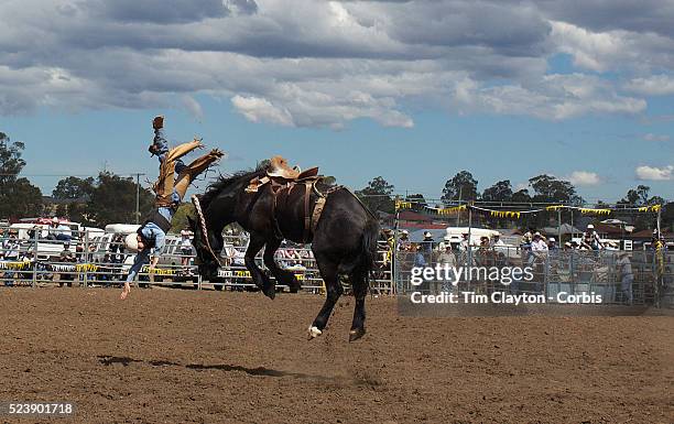 Grant Lane from the Scone region flips head over heals off his mount during the Novice Saddle Bronc riding at the Branxton Rodeo at Branxton, Hunter...