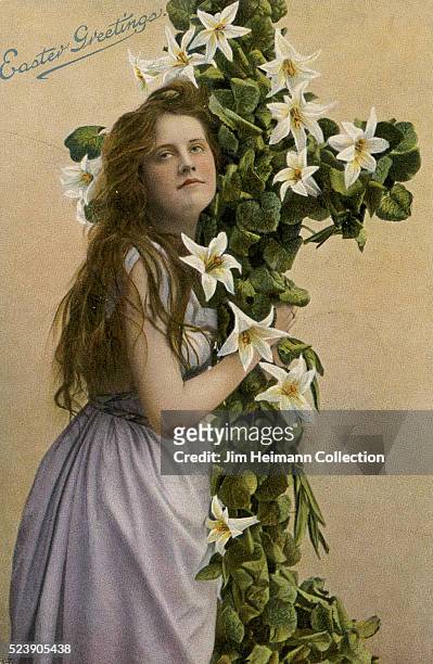 Easter postcard featuring young woman holding crucifix covered with lilies.