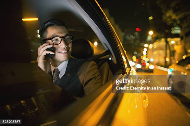 businessman using phone in car - asian man car stock pictures, royalty-free photos & images