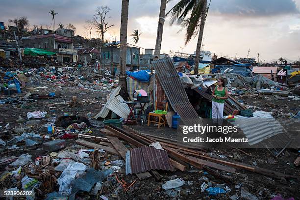 Woman stands in front of a temporary shelter constructed near where her house once stood, Tacloban city. More than two weeks have passed after Super...