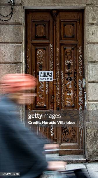 Sign announcing a flat for rent is seen on a graffiti covered door in the Ciutat Vella district of Barcelona, Catalonia, Spain, 25 January 2014....