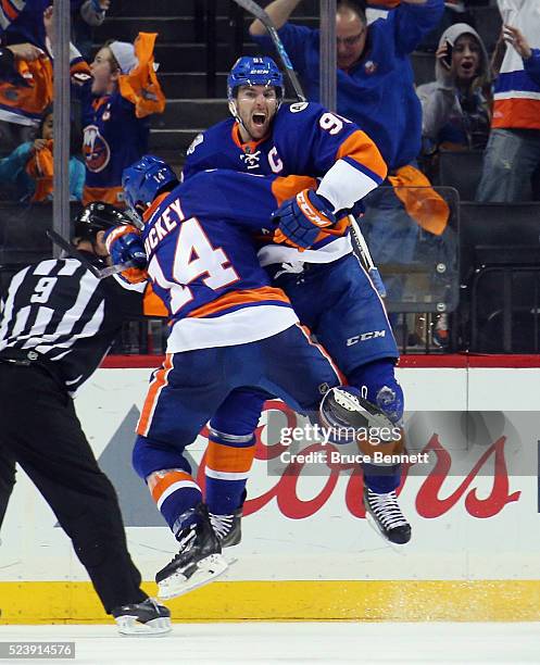 John Tavares of the New York Islanders celebrates his game winning goal at 10:41 of the second overtime against the Florida Panthers and is joined by...