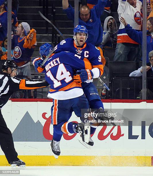 John Tavares of the New York Islanders celebrates his game winning goal at 10:41 of the second overtime against the Florida Panthers and is joined by...