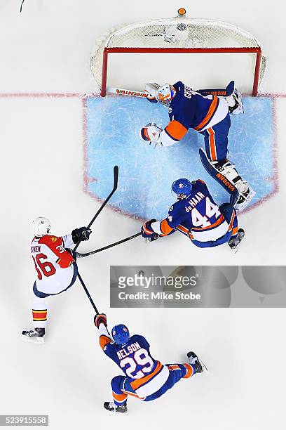 Thomas Greiss, Calvin de Haan and Brock Nelson of the New York Islanders defend the net against Jussi Jokinen of the Florida Panthers in Game Six of...