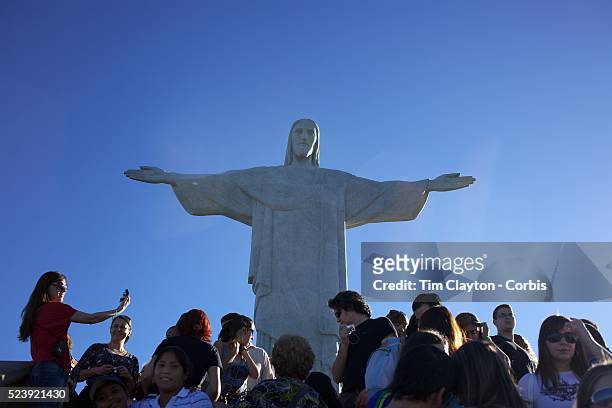 Visitors at the iconic Cristo Redentor, Christ the Redeemer statue sits atop the mountain Corcovado. The Christ statue was voted one of the seven...