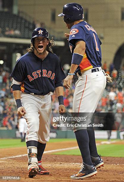 Colby Rasmus of the Houston Astros celebrates his game-tying two-run home run with Carlos Correa during the ninth inning against the Boston Red Sox...