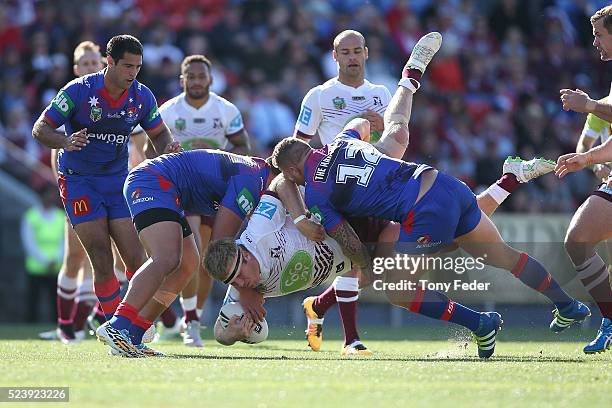 Jake Trbojevic of Manly is tackled by the Knights defence during the round eight NRL match between the Newcastle Knights and the Manly Sea Eagles at...