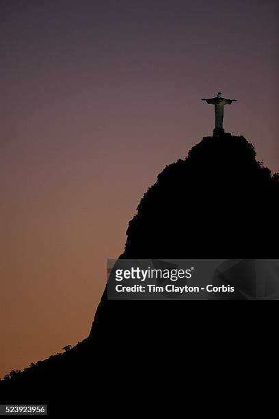 The iconic Cristo Redentor, Christ the Redeemer statue at sunset atop the mountain Corcovado shot from Suger Loaf Mountain. The Christ statue was...
