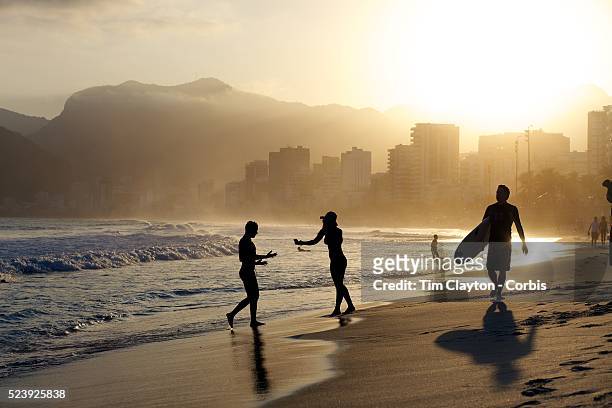 Late afternoon beach scene at Arpoador Beach with Ipanema and Leblon in the distance. Rio de Janeiro, Brazil. 8th August 2010. Photo Tim Clayton...