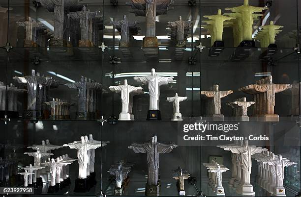 Statues of Christ the Redeemer on sale in the souvenir shop on site. The iconic Cristo Redentor, Christ the Redeemer statue sits atop the mountain...