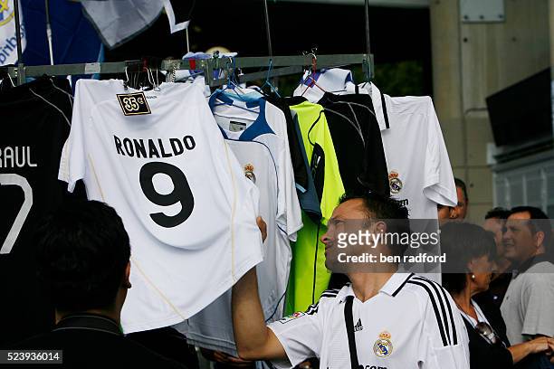Real Madrid fan looks at a Cristiano Ronaldo shirt at a merchandising stall before the La Liga 1st Division match between Real Madrid and...