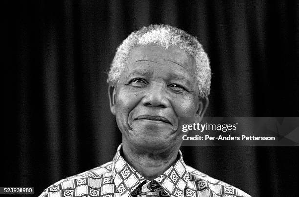 Former President Nelson Mandela of South Africa speaks to visitors on March 8, 1999 in his residence in Houghton, a suburb of Johannesburg, South...