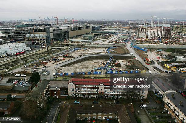 Construction of the site of the 2012 London Olympics, in Stratford, London, UK. The photograph shows local resident housing in the foreground, and...