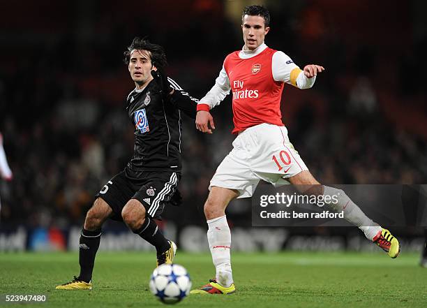 Robin van Persie of Arsenal and Stefan Savic of Partizan Belgrade during the UEFA Champions League Group H match between Arsenal and Partizan...