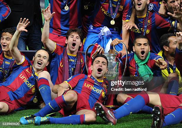 Andres Iniesta, Lionel Messi, Xavi Hernandez and Danny Alves of Barcelona celebrate winning the 2011 UEFA Champions League Final between Barcelona...