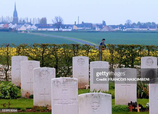 Person with a bagpipes walks past the cemetery of the Australian Memorial of the World War I battle of the Somme in Villers-Bretonneux, on April 25,...