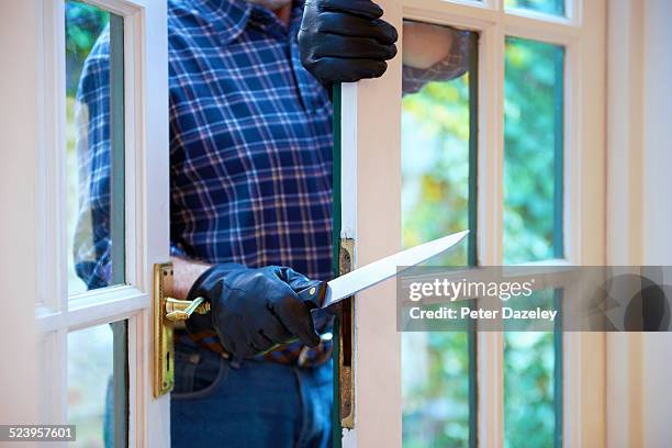 burglar entering with knife - burglary stock pictures, royalty-free photos & images