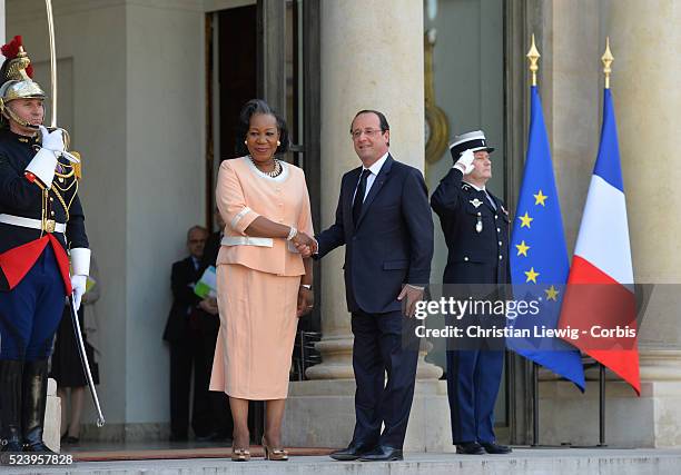 French President Francois Hollande, left, welcomes interim Central African Republic President Catherine Samba-Panza, as they pose for photographers...