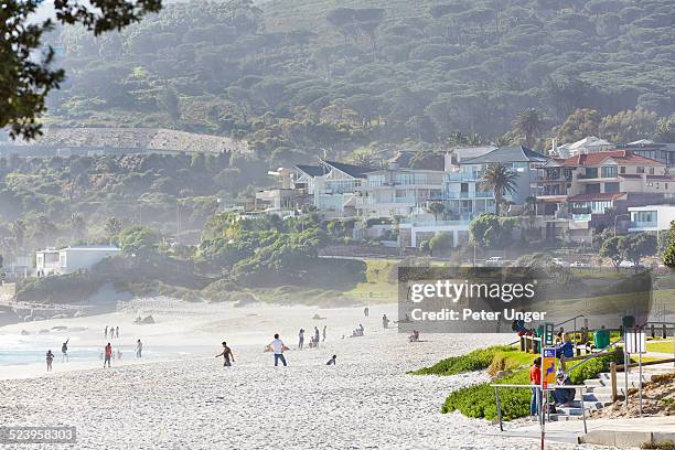 people enjoying the sand at clifton beach - camps bay stock-fotos und bilder