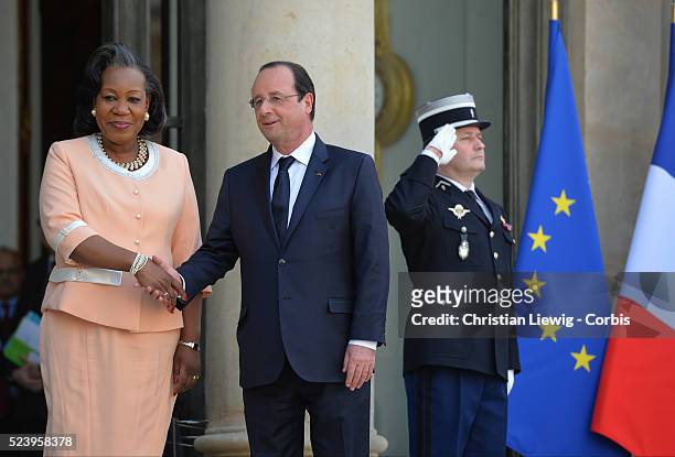 French President Francois Hollande, left, welcomes interim Central African Republic President Catherine Samba-Panza, as they pose for photographers...