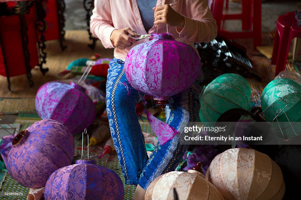 Woman making lanterns by hand, Vietnam