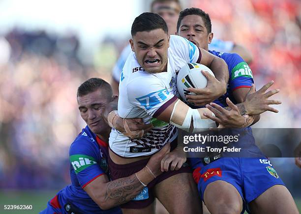 Dylan Walker of the Manly Sea Eagles is tackled by the Knights defence during the round eight NRL match between the Newcastle Knights and the Manly...