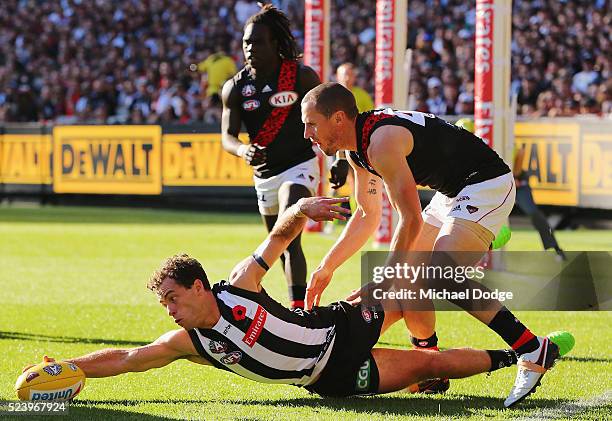 Jarryd Blair of the Magpies and James Kelly of the Bombers compete for the ball during the round five AFL match between the Collingwood Magpies and...