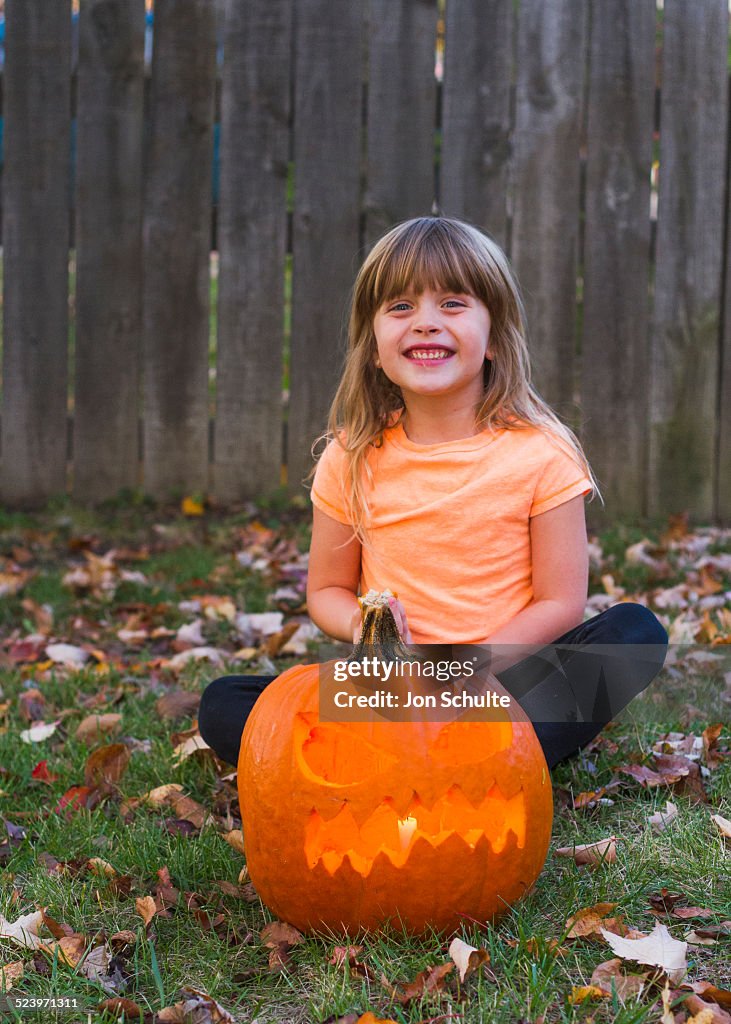 Excited girl with Halloween pumpkin