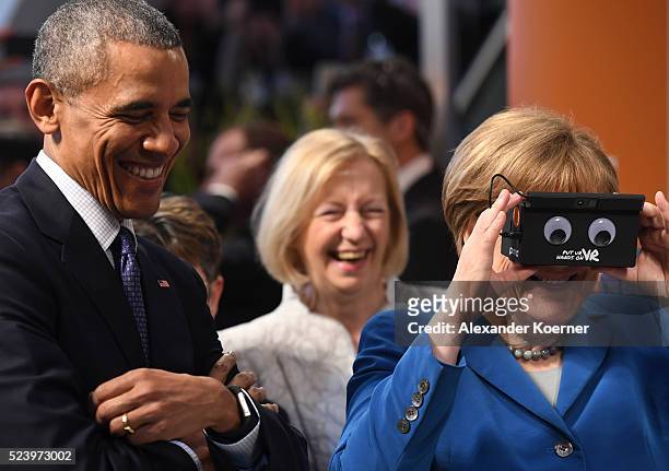 President Barack Obama and German Chancellor Angela Merkel visit the ifm electronics stand at hall 9 at the Hannover Messe industrial trade fair on...