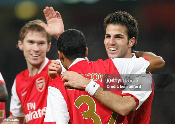 Happy Cesc Fabregas of Arsenal celebrates his second goal with Aleksander Hleb and Theo Walcott during the Champions League Group H match between...