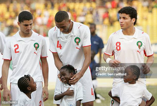 Abdesiam Ouaddou of Morocco makes the ball girls laugh during the team line ups during the African Cup of Nations 2008 Group A match between Guinea...