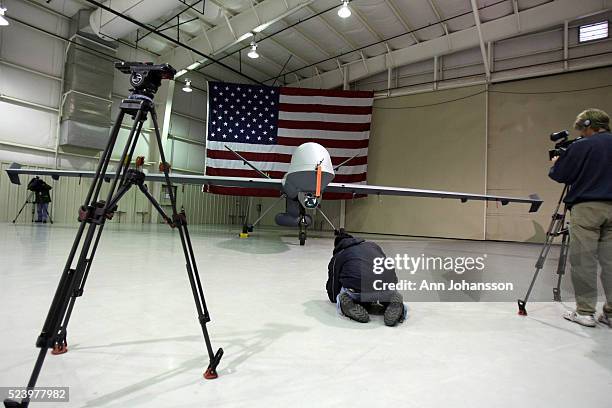 Cameramen get footage as the U.S. Customs and Border Protection Office of Air and Marine shows it's first Predator B unmanned aircraft system at the...