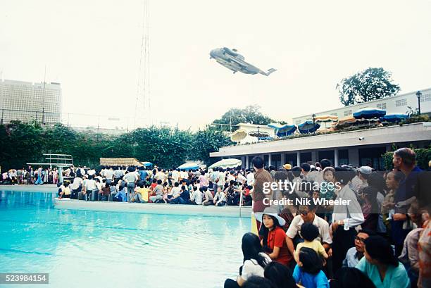 Crowds of Vietnamese and Western evacuees wait around the swimming pool inside the American Embassy compound in Saigon hoping to escape Vietnam via...