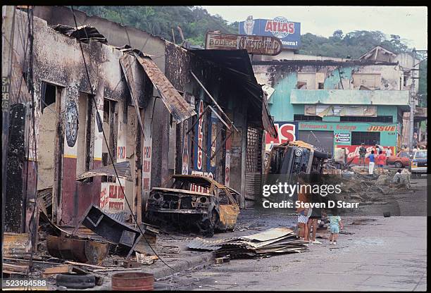 Burned cars and destroyed buildings are all that remain in a section of Panama after the U.S. Invasion. The United States invaded Panama in 1989 to...