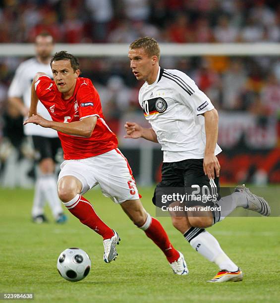 Lukas Podolski of Germany runs past Dariusz Dudka of Poland during the Group B match of the UEFA Euro 2008 Finals between Gerrmany and Poland at the...