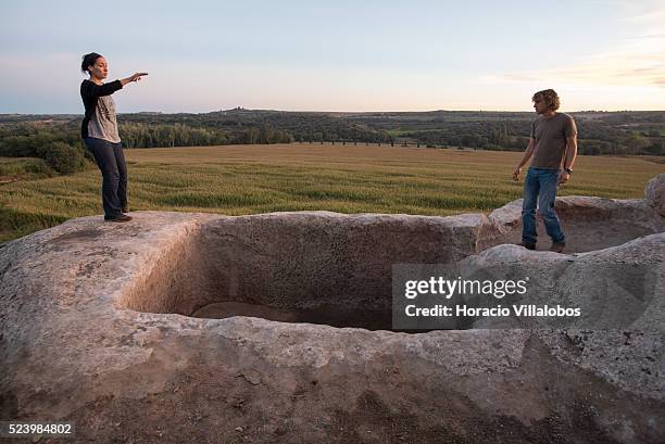 Enologists Valvanera Martinez de Toda and Joan Soler inspect one of the ancient fermentation vats at Costers del Sio vineyards, in Balaguer, Spain,...