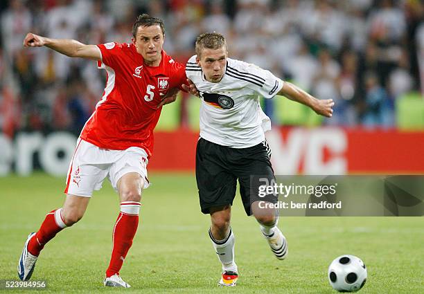 Lukas Podolski of Germany battles with Dariusz Dudka of Poland during the Group B match of the UEFA Euro 2008 Finals between Gerrmany and Poland at...
