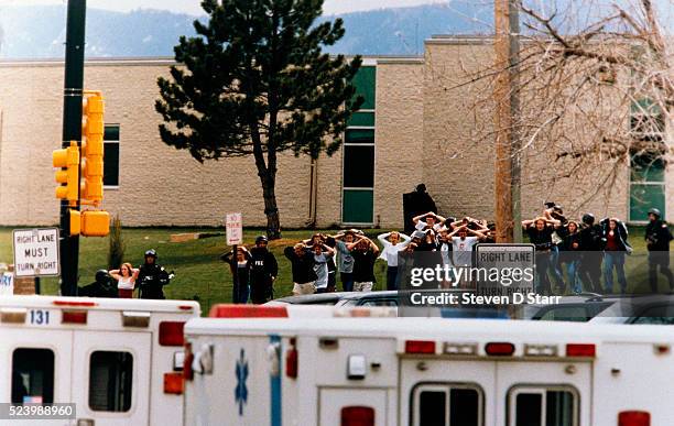 Littleton, Colorado: Students run out of the Columbine High School as 2 gunmen went on a shooting spree killing fifteen, including themselves.