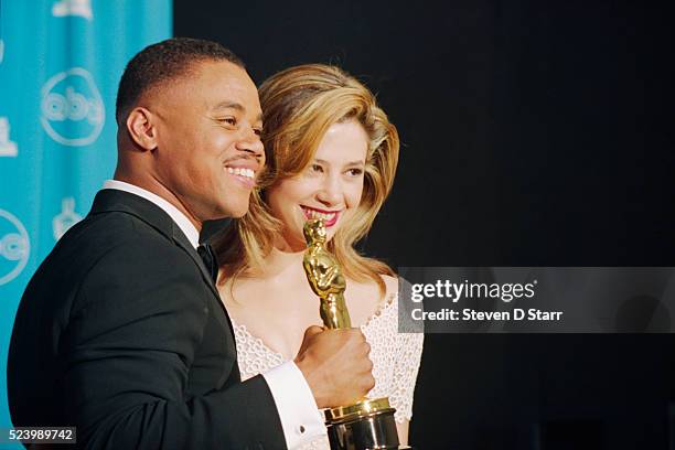 Best Supporting actor Cuba Gooding, Jr. Holds the Oscar he won at the 69th annual Academy Awards for his role in Jerry Maguire, with presenter Mira...