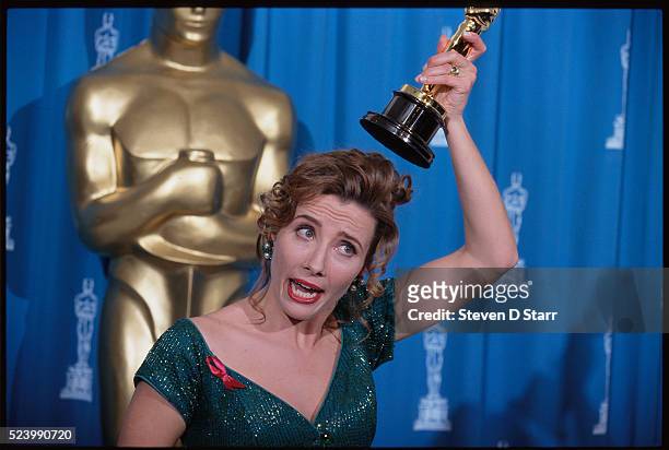 Emma Thompson holds her Oscar statuette over her head at the 65th Academy Awards. She won the Best Actress award for her role in Howards End.