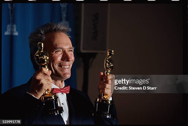 Clint Eastwood holds his Oscars at the 65th Academy Awards Ceremony. He won the awards for Best Picture and Best Director for his 1992 film,...