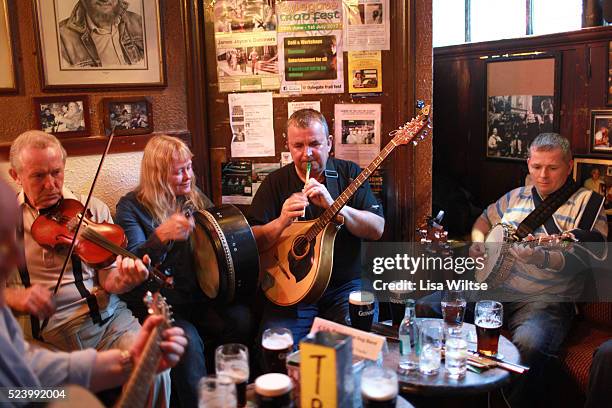 Musician's playing in O'Donoghue's Bar, Dublin, Ireland. O'Donoghue's is known for it's traditional Irish music. It has been frequented of the years...