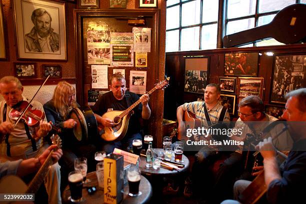 Musician's playing in O'Donoghue's Bar, Dublin, Ireland. O'Donoghue's is known for it's traditional Irish music. It has been frequented of the years...