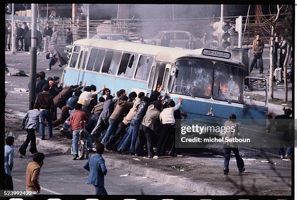 Young men protest against the government of the current Shah, Mohammed Reza Pahlavi. The Shah's government was overthrown in October in favor of an...