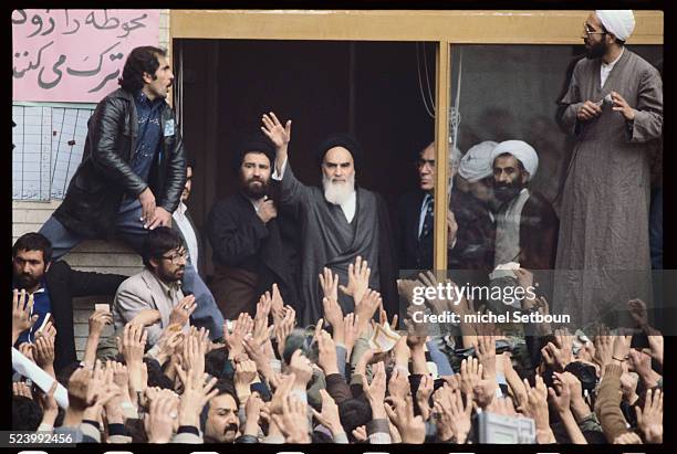 Ayatollah Khomeini waves to a crowd of enthusiastic supporters on his return to Tehran.